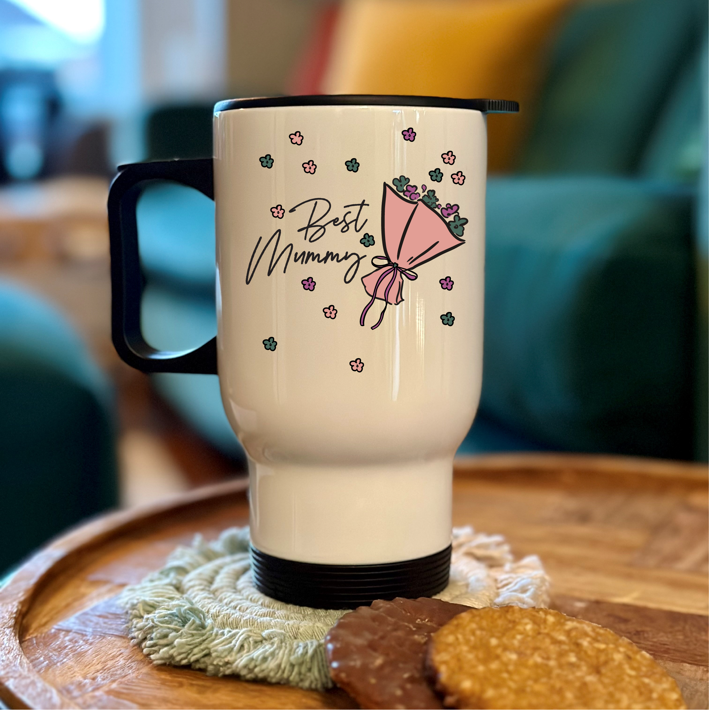 White travel mug with 'Best Mummy' and an umbrella design on a wooden table.