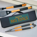 Set of BBQ tools with a personalized case on a gray surface