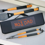 Barbecue tool set with 'No. 1 Dad' case on a gray surface