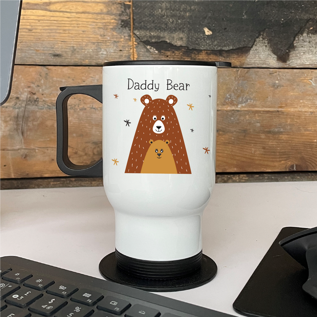 White travel mug with a bear illustration and 'Daddy Bear' text on a wooden desk.
