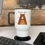 White travel mug with a bear illustration and 'Daddy Bear' text on a wooden desk.