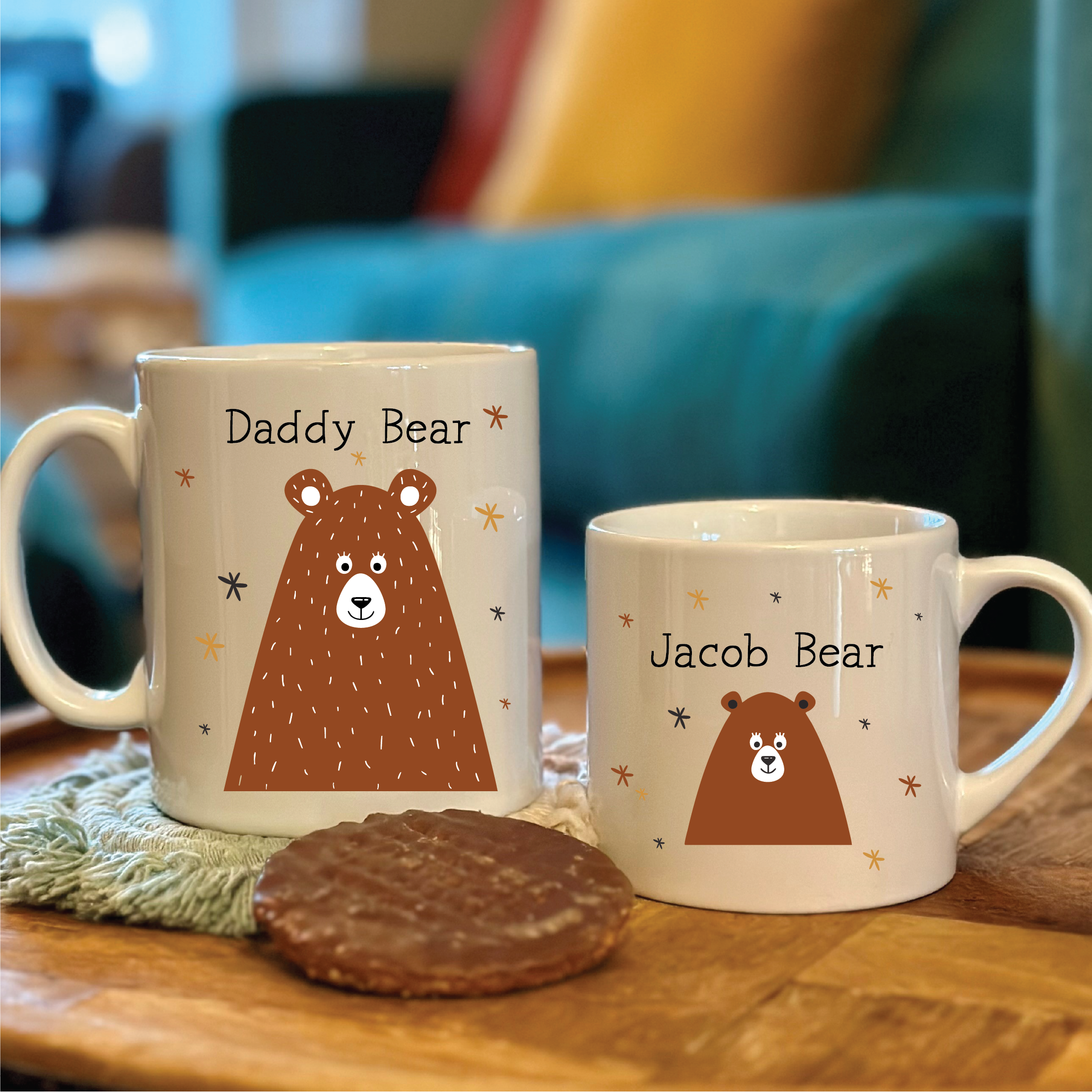 Two bear-themed mugs on a table with a blurred background