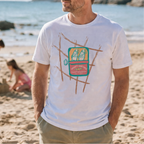 Man wearing a white t-shirt with a graphic design on a beach