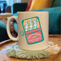 Mug with sardine can design on a wooden table