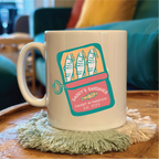 Mug with sardine can design on a wooden table