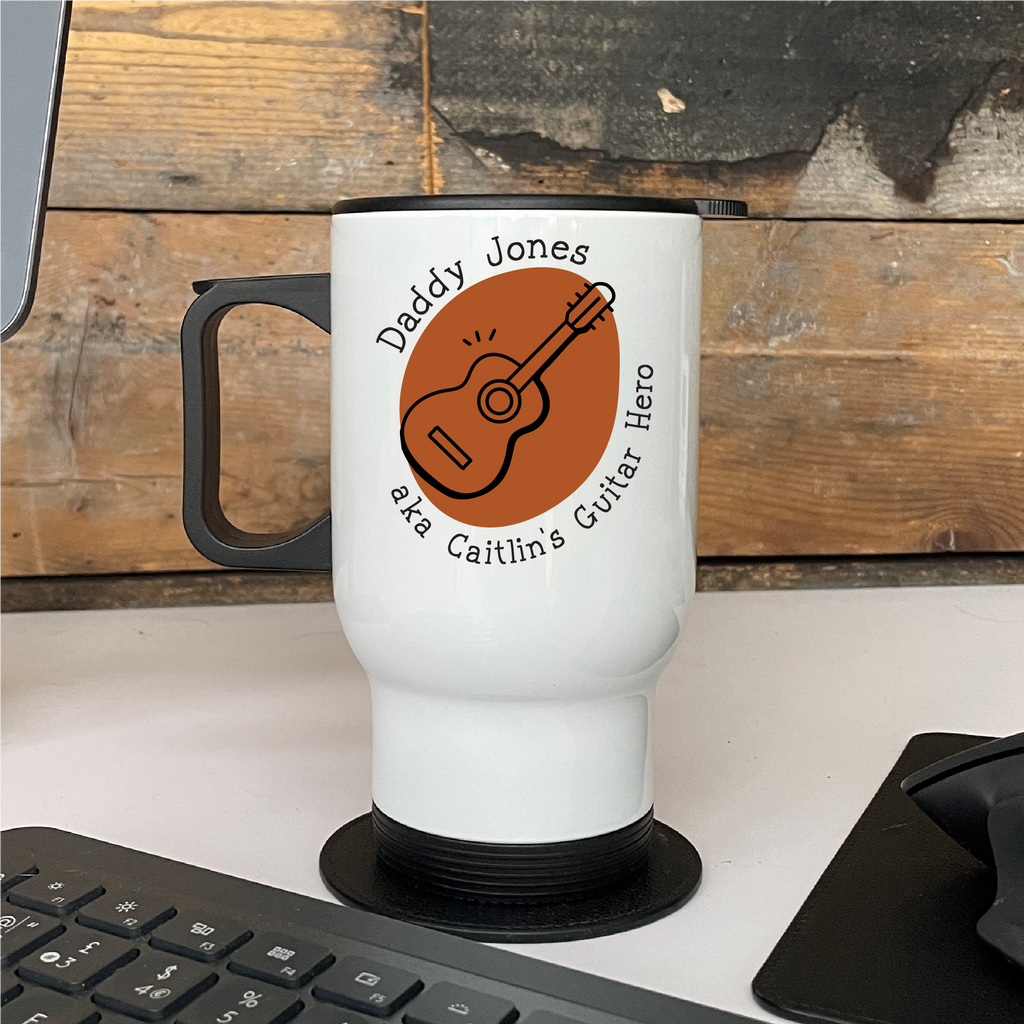 White mug with guitar design and text on a wooden surface