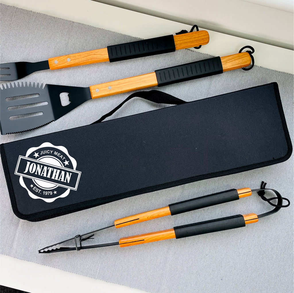 Set of barbecue tools with personalized case on a gray surface