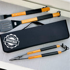 Set of barbecue tools with personalized case on a gray surface
