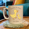Mug with duck design and text on a table with a blurred background