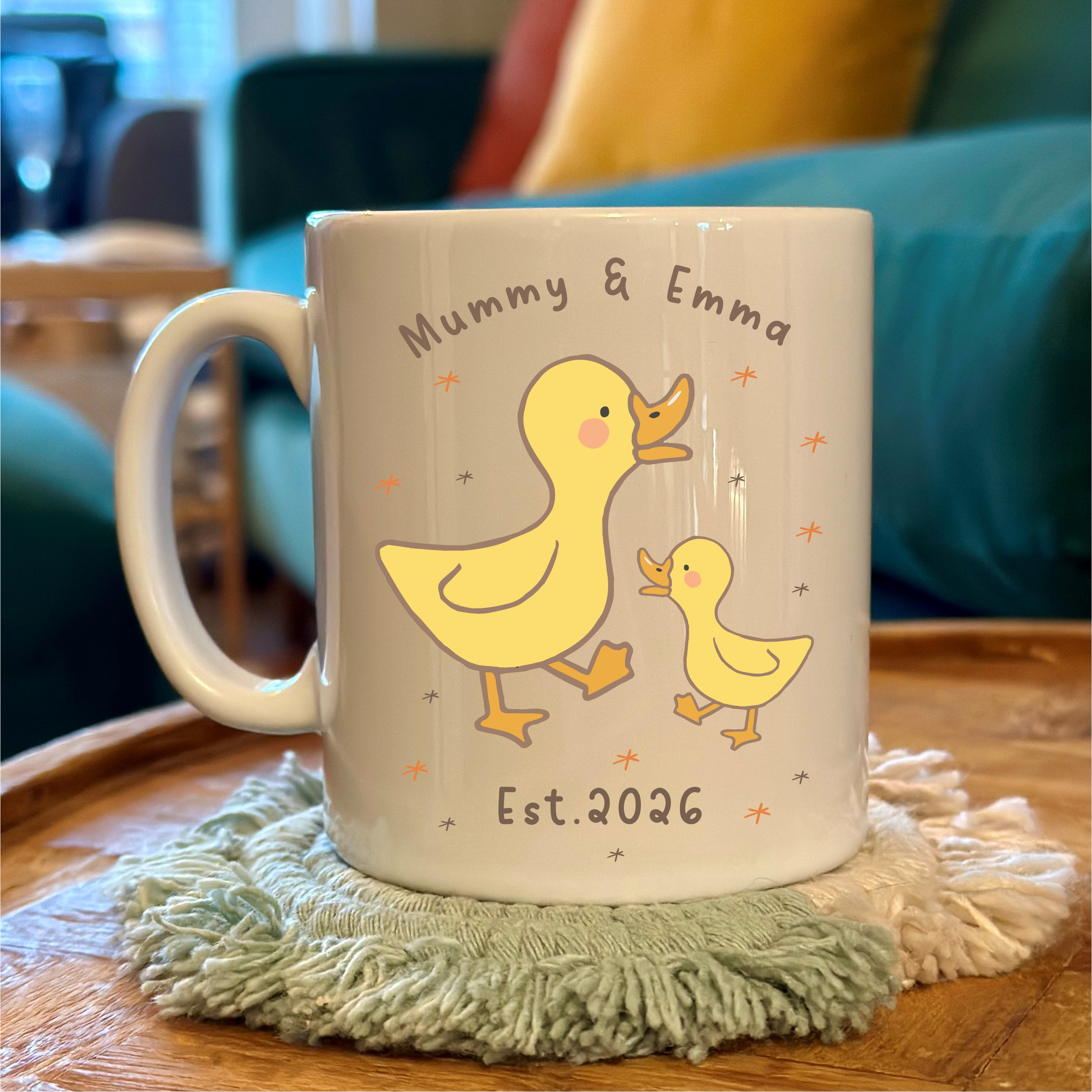 Mug with duck design and text on a table with a blurred background