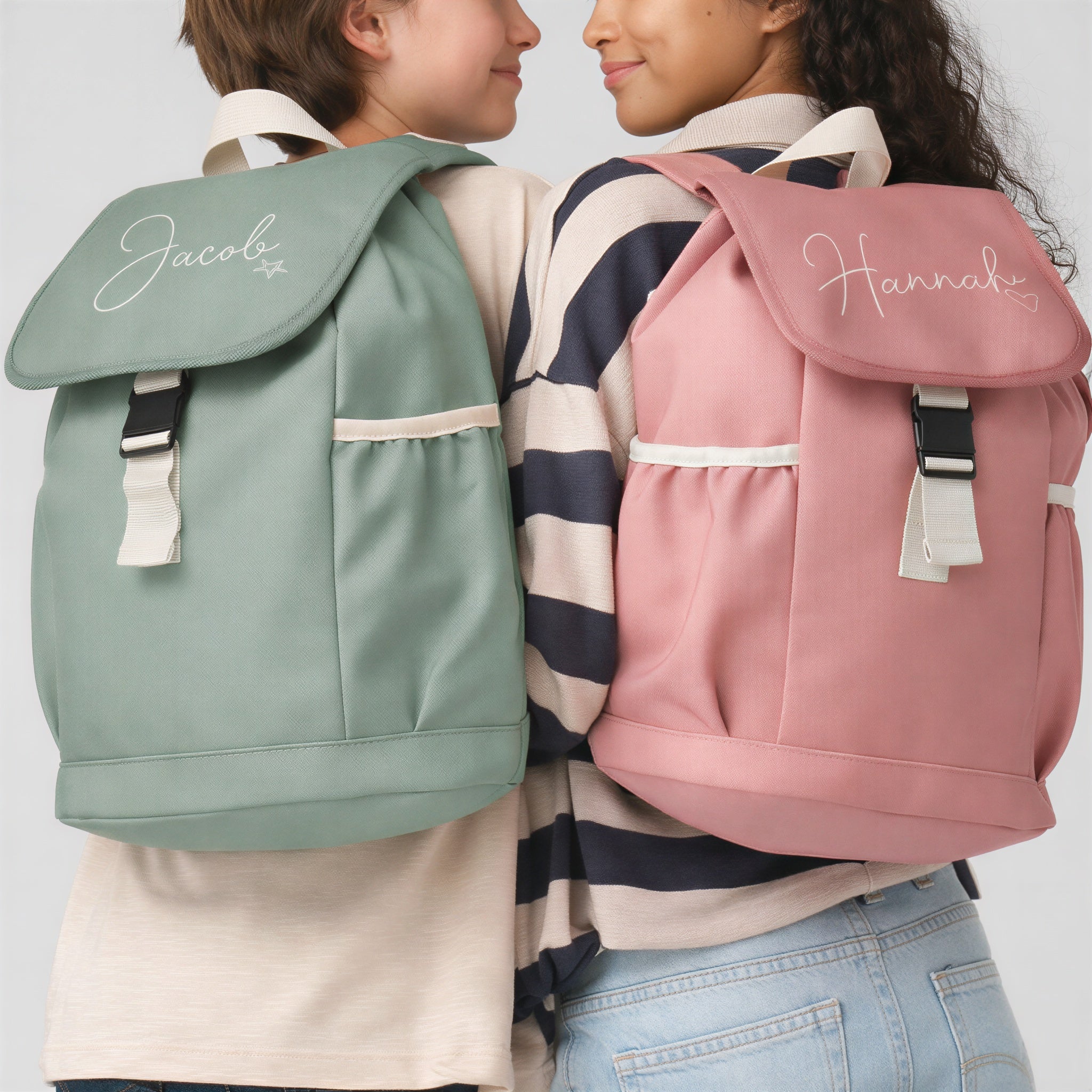 Two children wearing personalized backpacks with names 'Jacob' and 'Hannah'.
