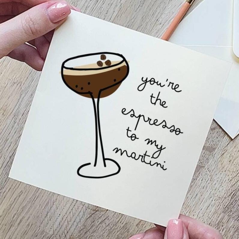 Card with a drawing of an espresso martini and text 'you're the espresso to my martini' held by a hand.