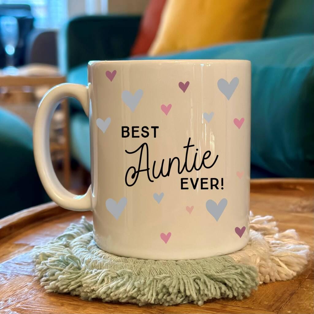 Mug with 'Best Auntie Ever!' text on a wooden table with a blurred background