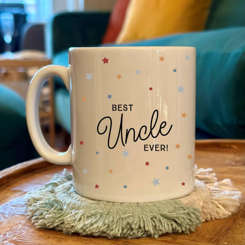 Mug with 'Best Uncle Ever!' text on a wooden table with a cozy background