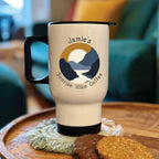 Travel mug with 'Jamie's Sunrise Hike Coffee' design on a wooden surface.