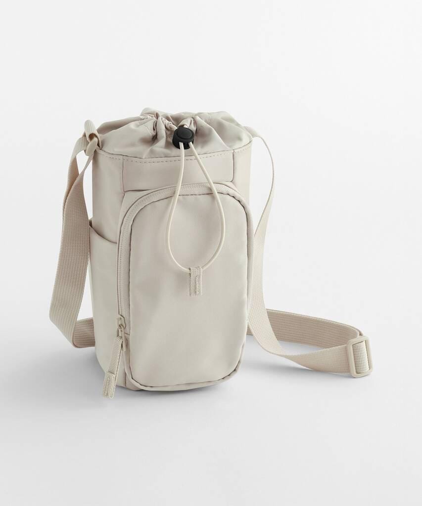 Beige drawstring bag with a strap on a light gray background