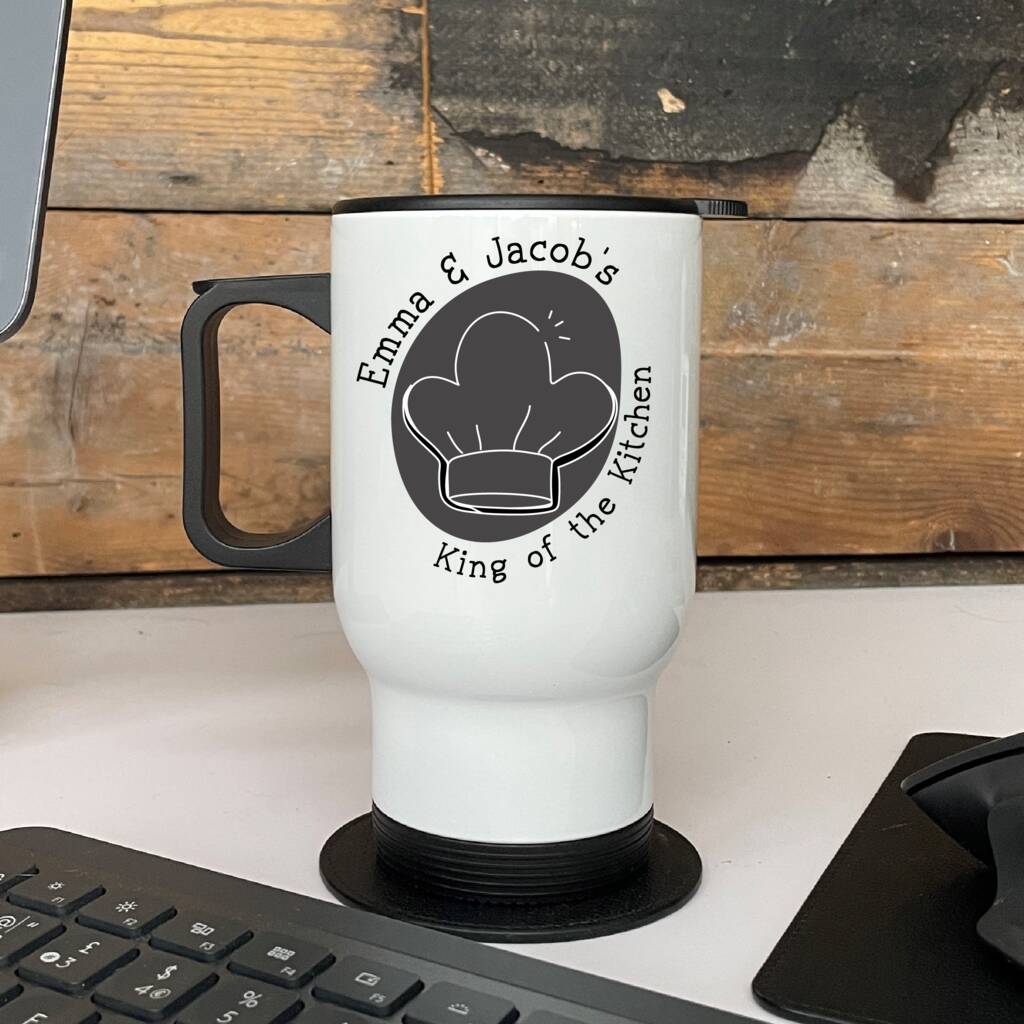 White mug with black handle and design on a wooden surface
