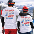 Two people wearing 'The Smith Family Ski Club' shirts on a snowy mountain.
