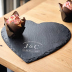 Heart-shaped slate board with a dessert on a wooden table