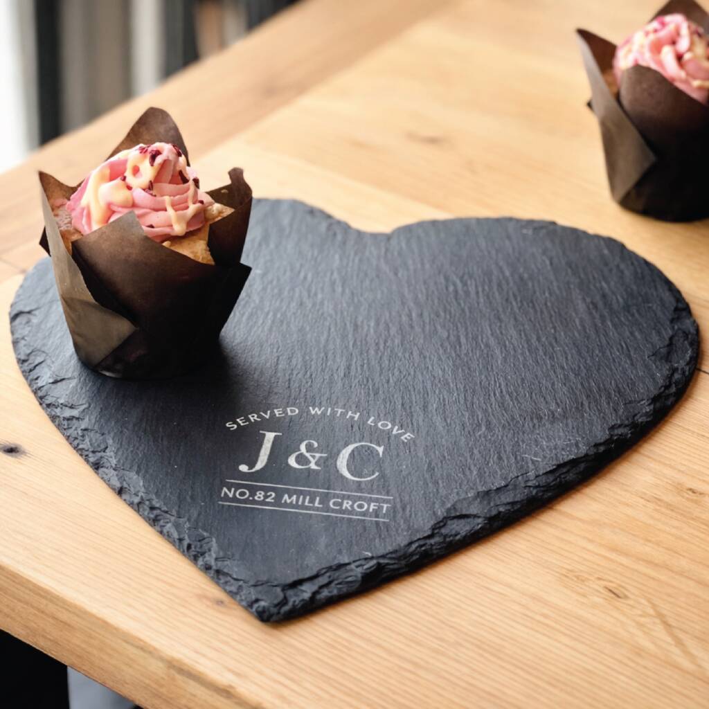 Heart-shaped slate board with a dessert on a wooden table